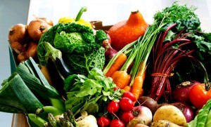 Cardboard box of assorted vegetables on kitchen counter